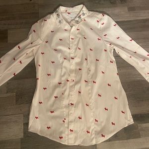 off white blouse. sparkly bling on collar. red dogs
